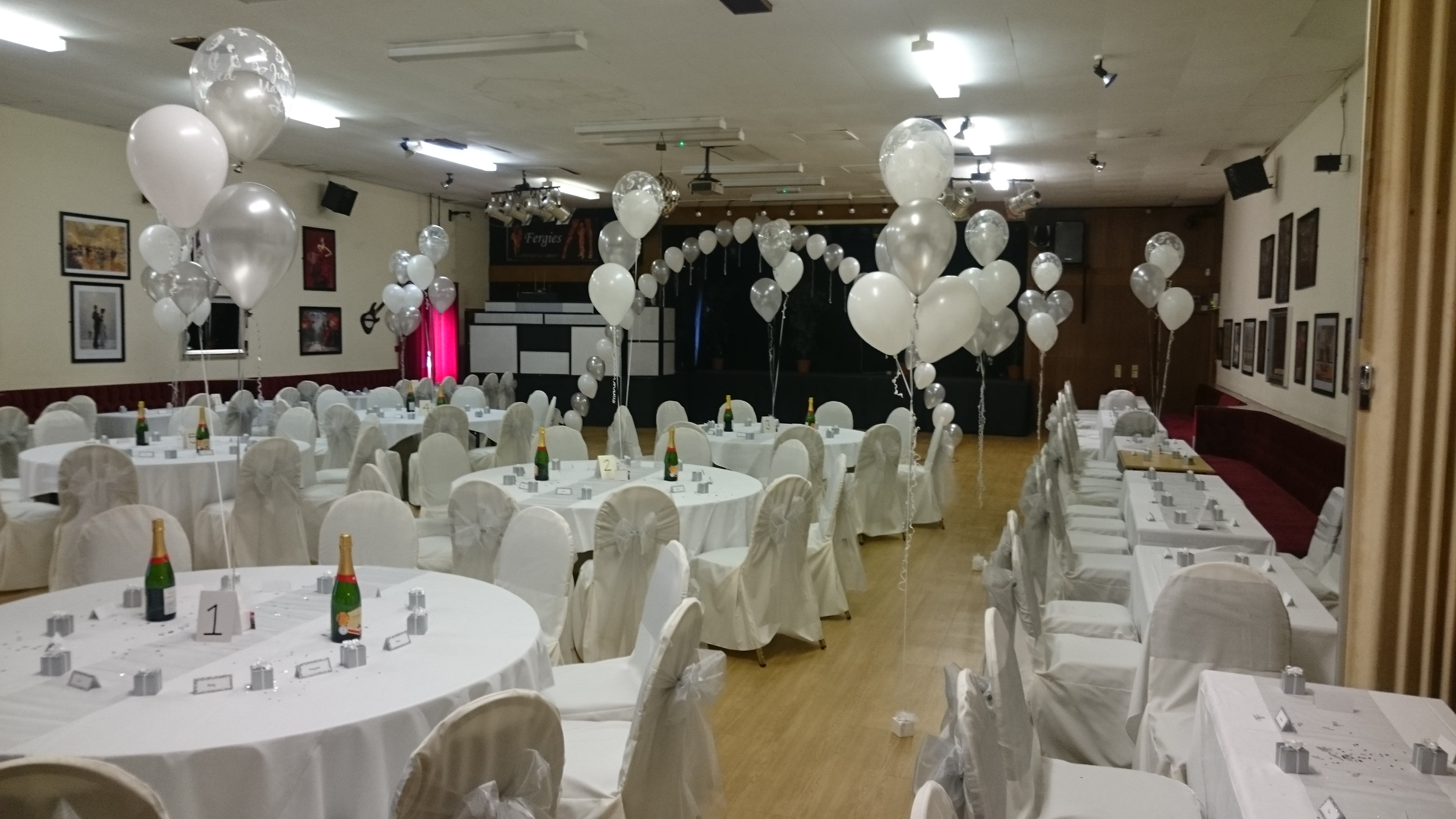 Read more about the article Wedding Reception at the Massey Ferguson Club Coventry. The use of arches, clouds and bouquets in a neutral colour worked really well.